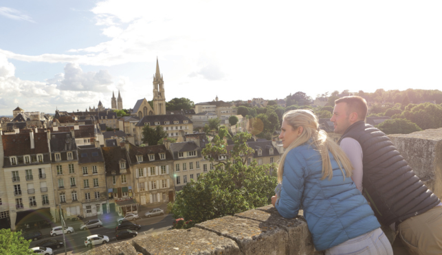 An image of a couple looking over the city of Caen